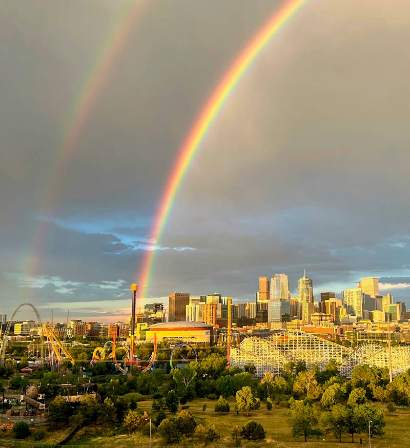 Denver skyline with double rainbow pictured above it
