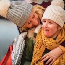 Image: An older woman warmly embracing a young woman.