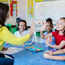 Kids in a classroom sitting with a teacher