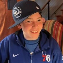 A smiling teenager with a disability who received support making his home more accessible in Denver