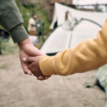 Adult and child holding hands