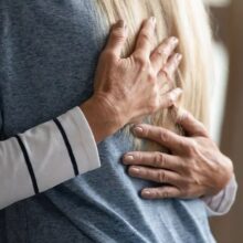 Two people hugging and offering support