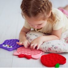 A young child plays with a fidget toy for neurodiverse students